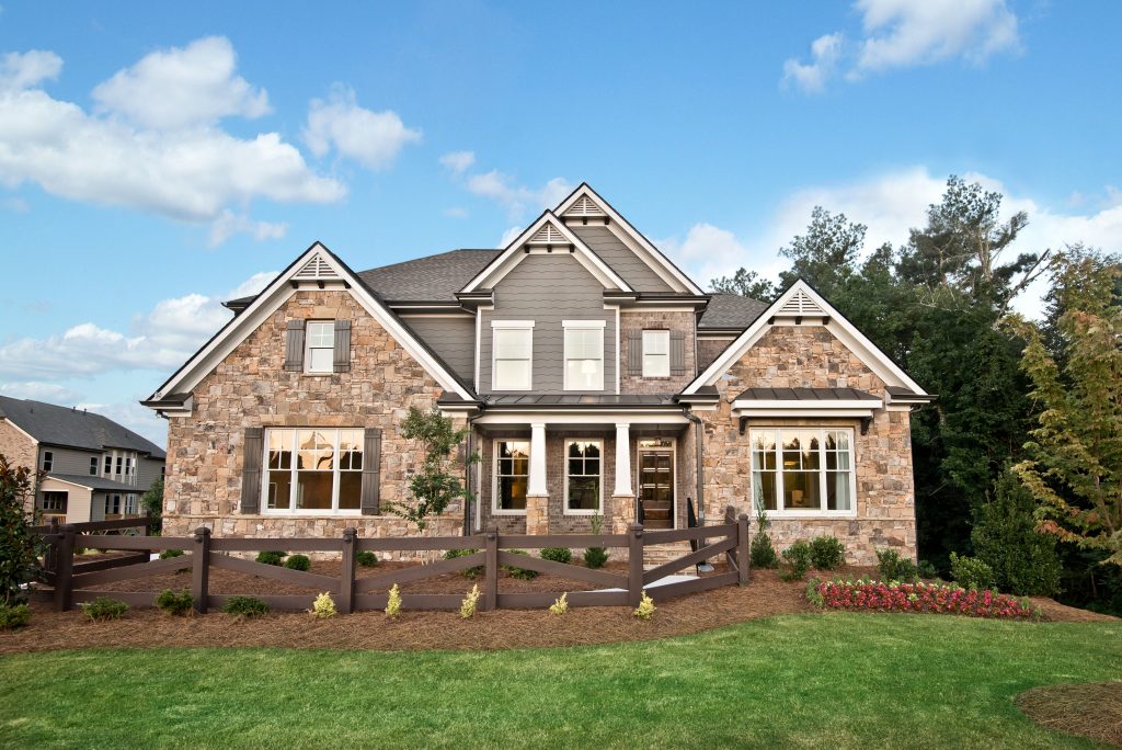 home real estate exterior with manicured lawn and crisp fall sky